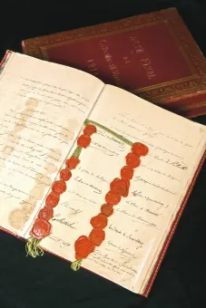 Papiercodex,  Folien, in rotem Ledereinband mit Goldprägung und dazugehöriger, lederbespannter, mit grünem Samt gefütterter Holzkassette, Siebzehn aufgedrückte Lacksiegel an schwarz-gelber Seidenschnur  aufgeschlagen: 37,8 x 53,5 x 5 cm, Kassette: 40 x 28,5 x 9 cm