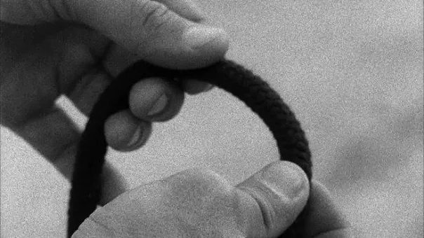 16mm transferred to HD, bw, silent, 3:00min, vinyl letters, 2m x 25cm