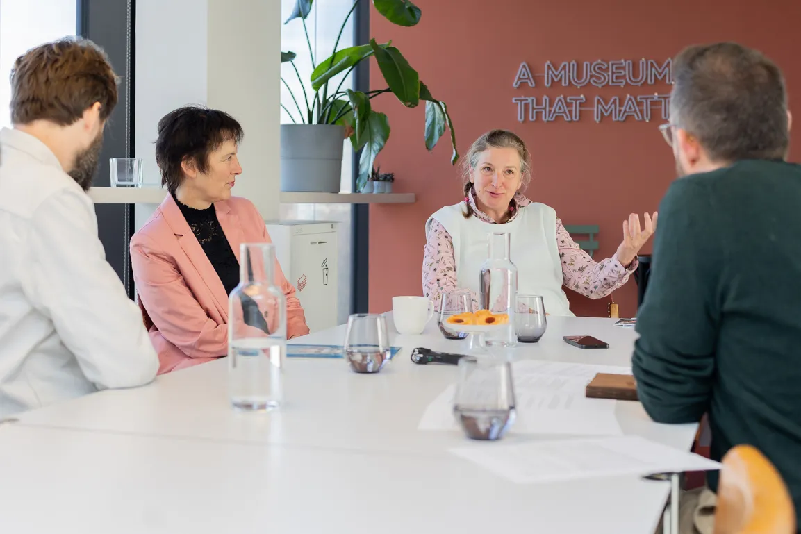 People sitting at an office desk and discussing