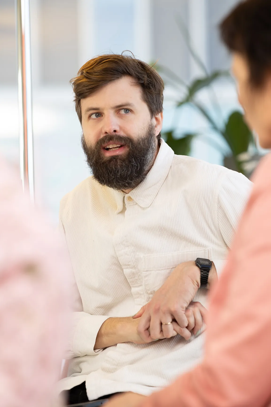 People sitting at an office desk and discussing