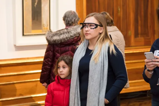 Young woman are looking at a picture in the museum.