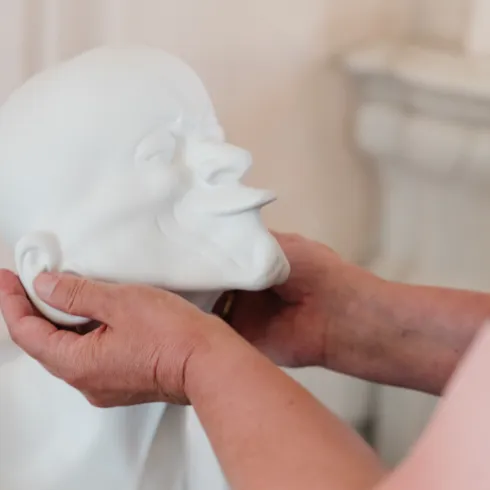 Hands touching a Messerschmidt head